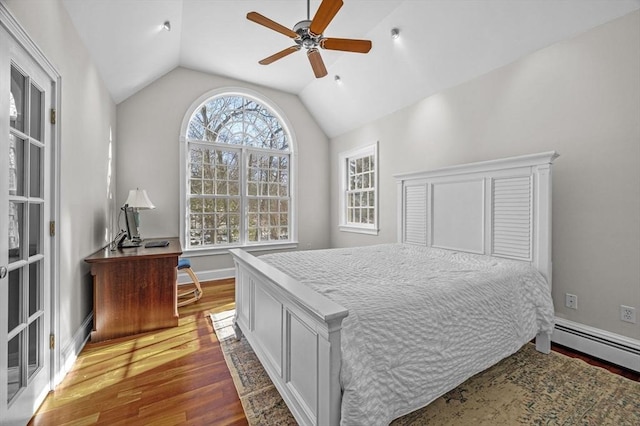 bedroom featuring ceiling fan, wood-type flooring, vaulted ceiling, and a baseboard heating unit