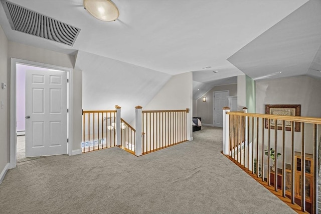 corridor featuring lofted ceiling and light carpet