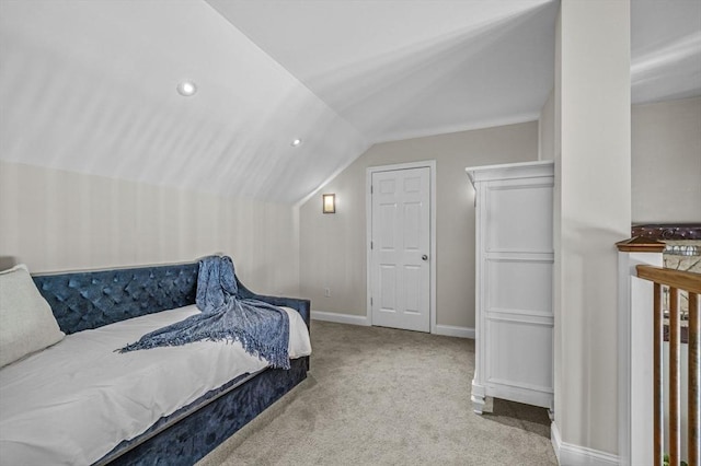 bedroom with light colored carpet and vaulted ceiling