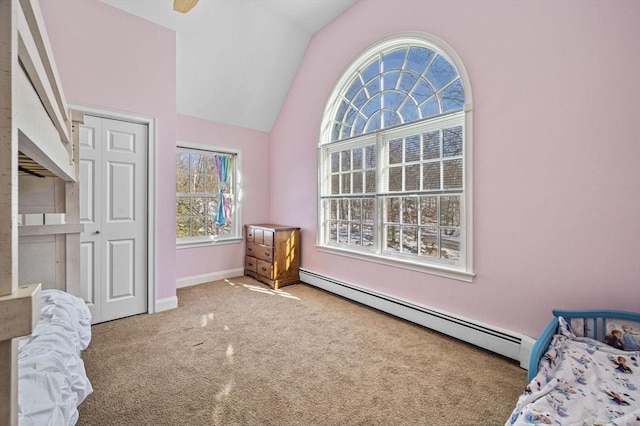 bedroom with ceiling fan, a baseboard heating unit, vaulted ceiling, light colored carpet, and a closet