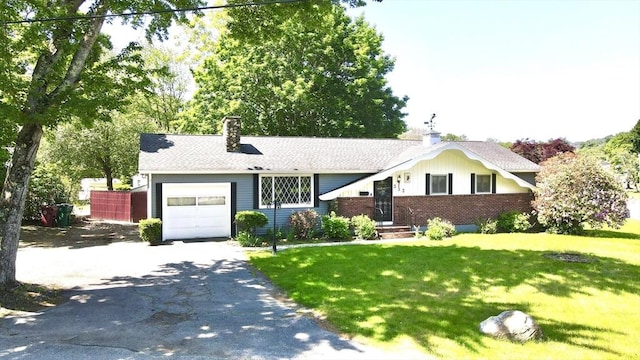 333 Clark Rd, Lowell, MA 01852 - ranch-style home featuring an attached garage, a chimney, asphalt driveway, a front lawn, and brick siding