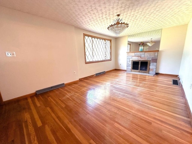 333 Clark Rd, Lowell, MA 01852 - unfurnished living room with baseboards, wood finished floors, and a fireplace