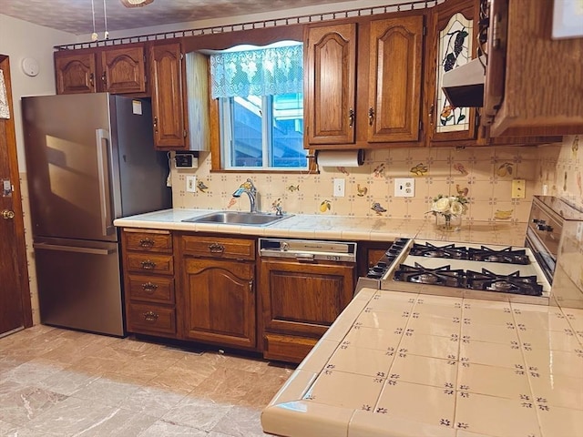 333 Clark Rd, Lowell, MA 01852 - kitchen with a sink, tile counters, freestanding refrigerator, stove, and backsplash