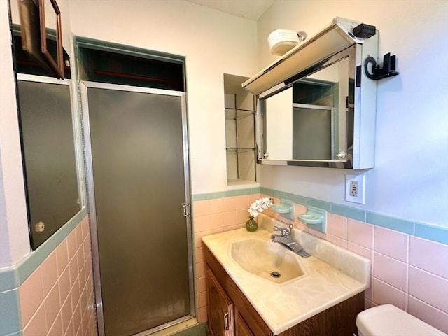 333 Clark Rd, Lowell, MA 01852 - full bath featuring tile walls, a wainscoted wall, vanity, a shower stall, and toilet