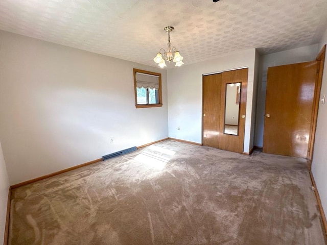 333 Clark Rd, Lowell, MA 01852 - carpeted spare room featuring a chandelier, baseboards, baseboard heating, and a textured ceiling