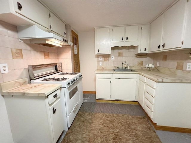 333 Clark Rd, Lowell, MA 01852 - kitchen featuring white range with gas stovetop, a sink, under cabinet range hood, decorative backsplash, and light countertops