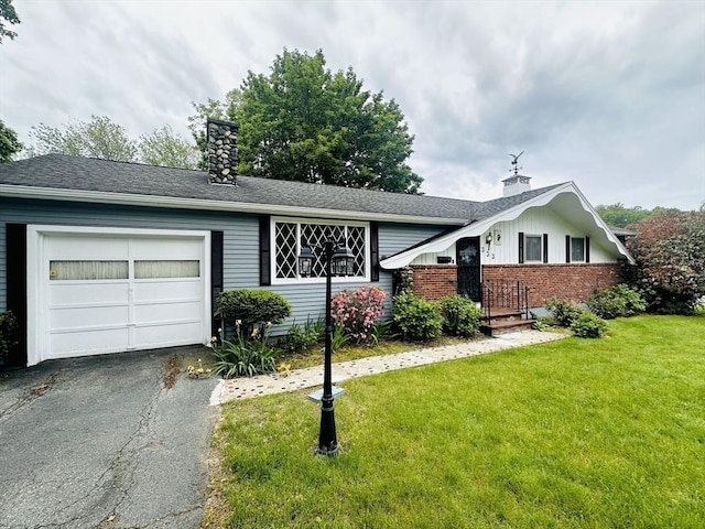 333 Clark Rd, Lowell, MA 01852 - view of front of property featuring a chimney, a front lawn, and driveway