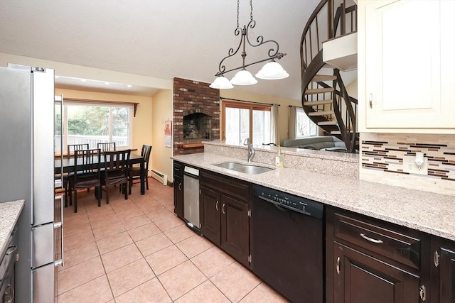 kitchen with stainless steel fridge, tasteful backsplash, sink, dishwasher, and hanging light fixtures