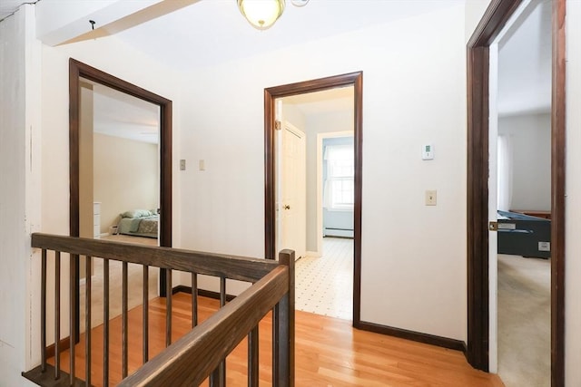 hallway featuring light wood-type flooring and baseboard heating