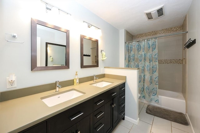 bathroom featuring tile patterned flooring, vanity, and shower / bath combo with shower curtain