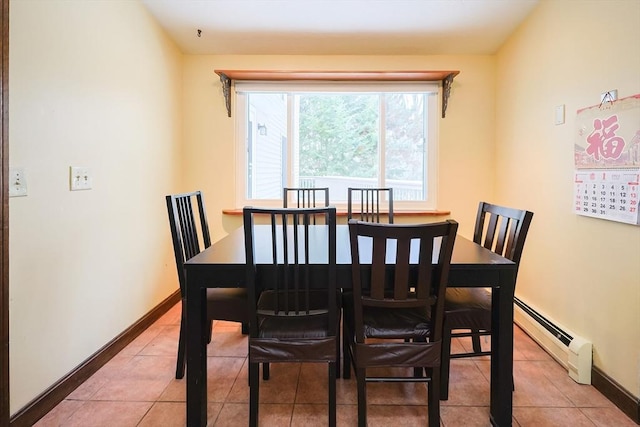 tiled dining area featuring a baseboard radiator