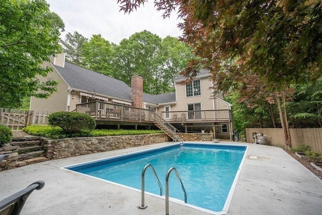 view of swimming pool with a deck and a patio