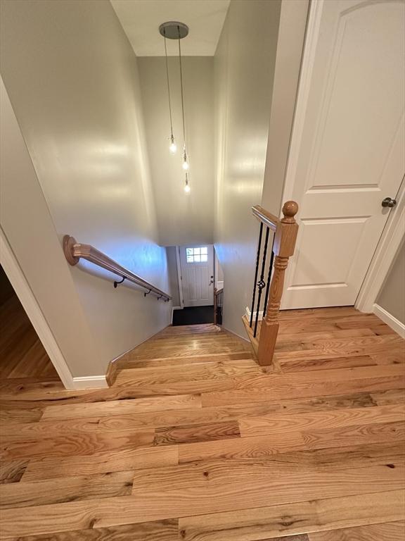 stairs featuring hardwood / wood-style flooring