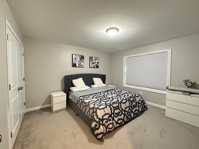 bedroom featuring light carpet