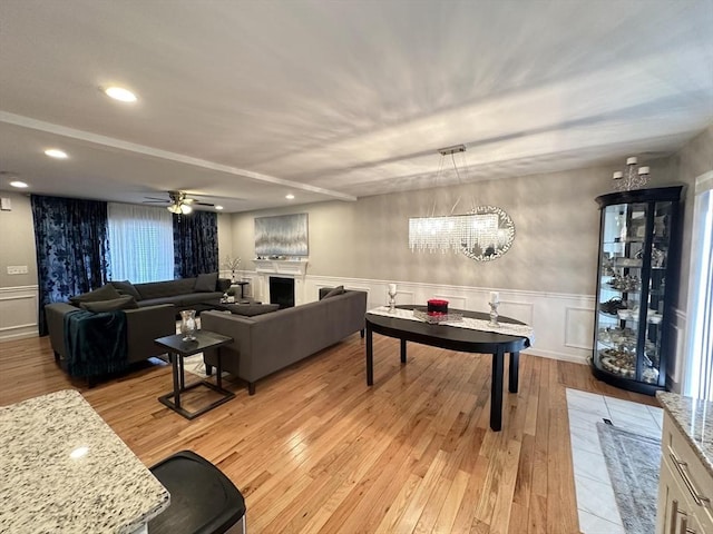 living room featuring ceiling fan and light wood-type flooring