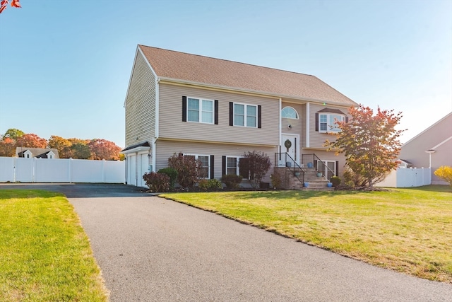 view of front of home with a garage and a front yard