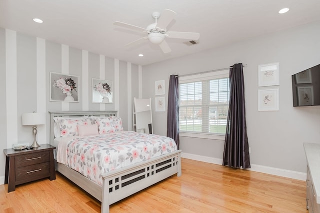 bedroom with light hardwood / wood-style floors and ceiling fan