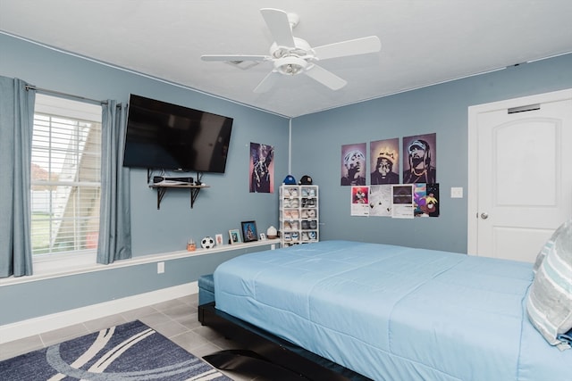 bedroom with ceiling fan, multiple windows, and light tile patterned floors