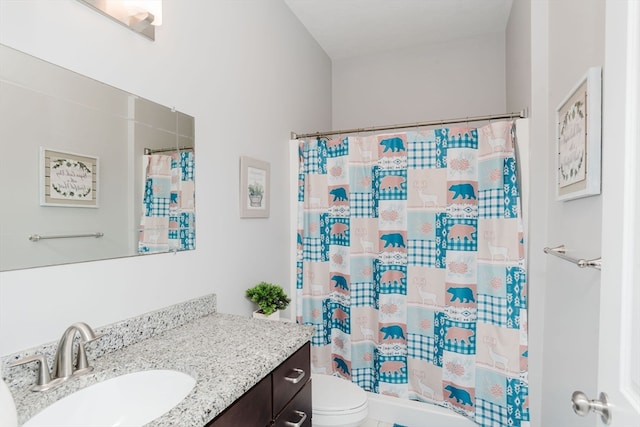 bathroom with curtained shower, vanity, and toilet