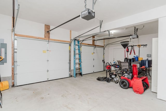 garage with a garage door opener and electric panel