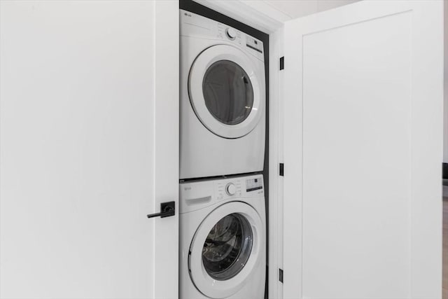 washroom with stacked washer and dryer