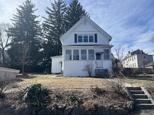 view of front of house with entry steps and fence