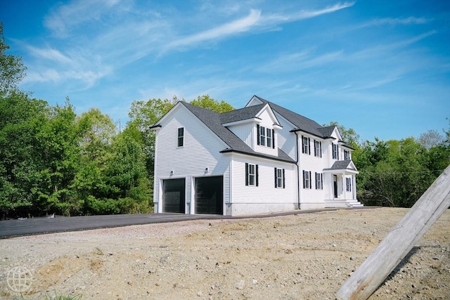 view of front of home featuring a garage and asphalt driveway