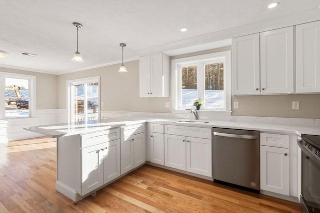 77 Minot Ave, Wareham, MA 02571 - kitchen with stainless steel dishwasher, a sink, ornamental molding, a peninsula, and light countertops