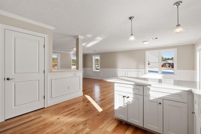 77 Minot Ave, Wareham, MA 02571 - kitchen with ornamental molding, light wood-type flooring, decorative light fixtures, a decorative wall, and a wainscoted wall