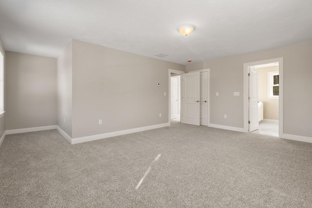 77 Minot Ave, Wareham, MA 02571 - unfurnished bedroom with light colored carpet, baseboards, and connected bathroom
