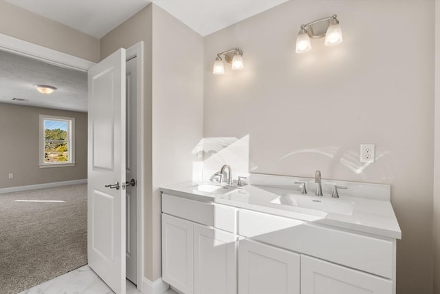 77 Minot Ave, Wareham, MA 02571 - bathroom with double vanity, baseboards, and marble look tiles