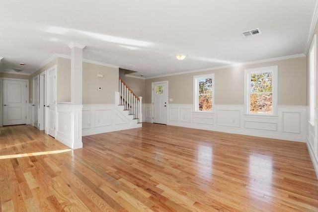 77 Minot Ave, Wareham, MA 02571 - unfurnished living room with light wood-style flooring, stairway, a wainscoted wall, decorative columns, and ornamental molding