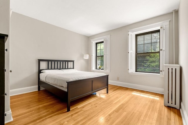 149 Winthrop Rd Unit 5, Brookline, MA 02445 - bedroom featuring baseboards, light wood-type flooring, and radiator heating unit