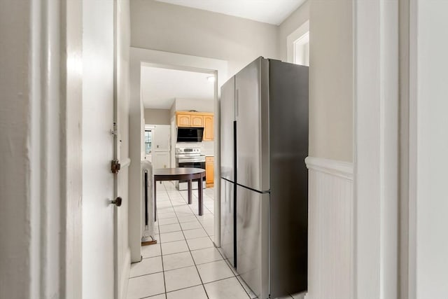 149 Winthrop Rd Unit 5, Brookline, MA 02445 - kitchen with stainless steel appliances, light brown cabinetry, light tile patterned flooring, and wainscoting
