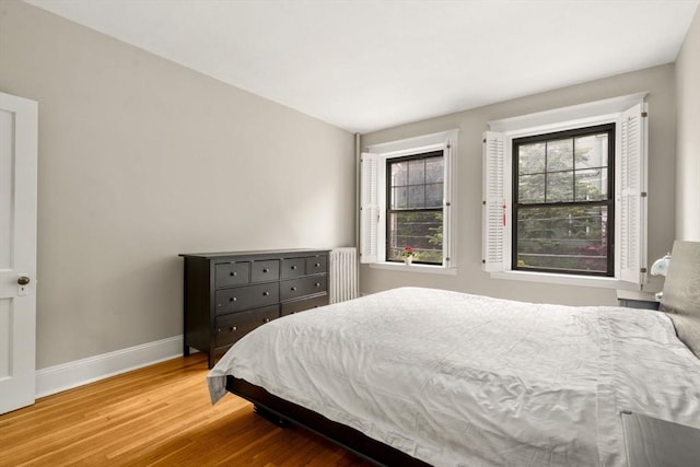149 Winthrop Rd Unit 5, Brookline, MA 02445 - bedroom featuring wood finished floors, baseboards, and radiator heating unit