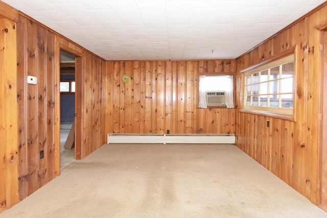 carpeted spare room with wood walls, an AC wall unit, and a baseboard heating unit