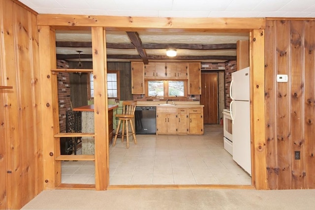 kitchen featuring beamed ceiling, white appliances, wooden walls, and sink