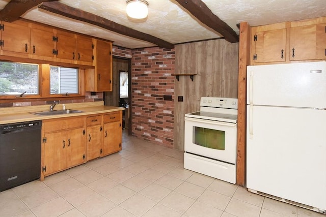 kitchen with light tile patterned flooring, white appliances, sink, wooden walls, and beam ceiling