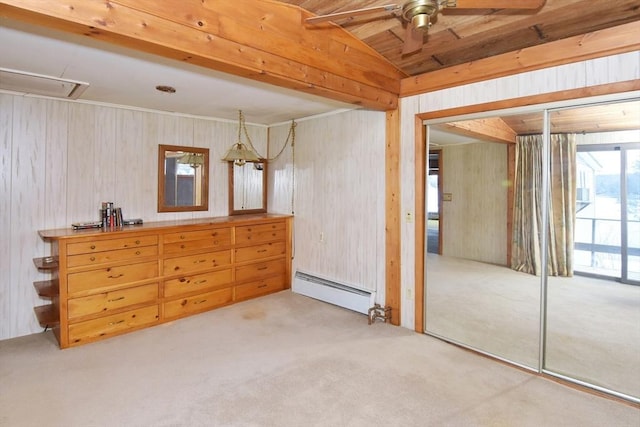 bedroom with wooden walls, ceiling fan, light carpet, and a baseboard heating unit