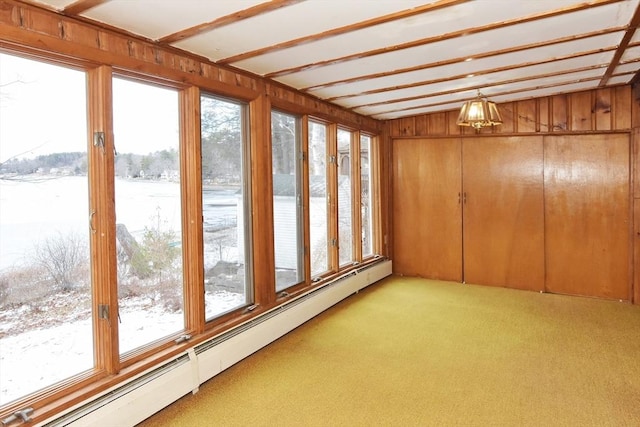 unfurnished sunroom featuring vaulted ceiling, plenty of natural light, and baseboard heating