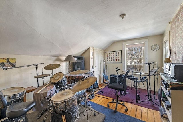 interior space with hardwood / wood-style flooring and vaulted ceiling