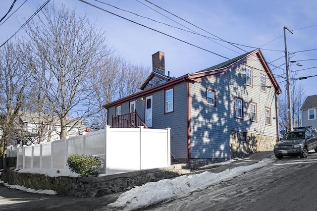 view of snow covered exterior with a balcony