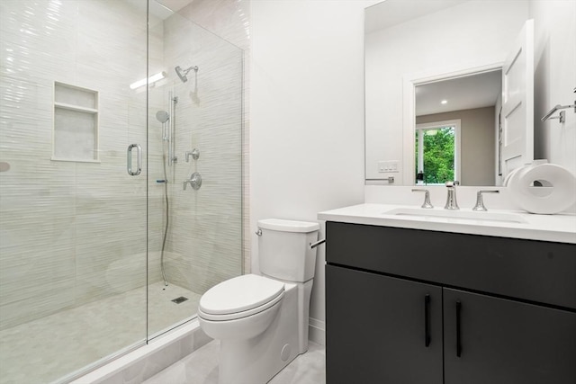 full bath featuring vanity, a shower stall, and toilet