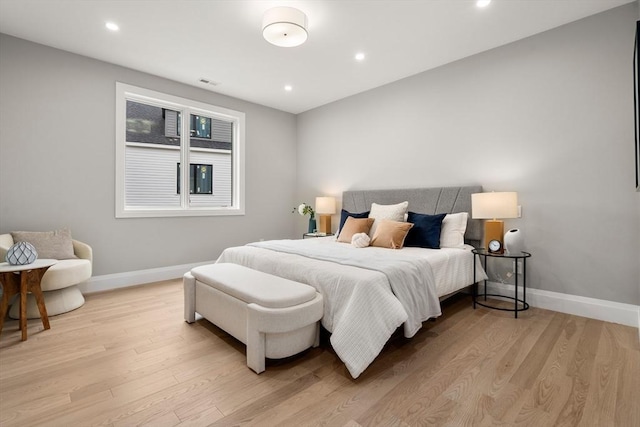 bedroom with visible vents, baseboards, and light wood-style flooring