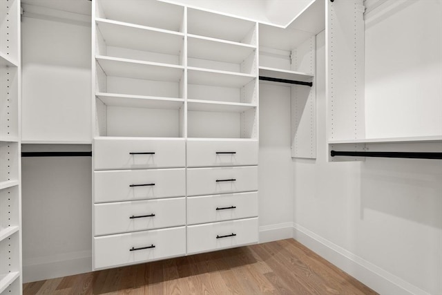 walk in closet featuring wood finished floors