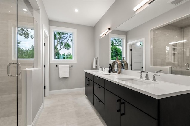 full bathroom featuring double vanity, visible vents, a stall shower, and a sink