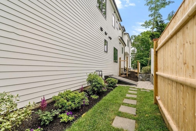 view of side of property featuring fence