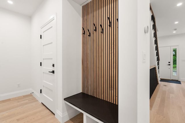 mudroom featuring recessed lighting, light wood-type flooring, and baseboards