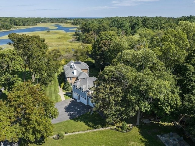 drone / aerial view featuring a forest view and a water view