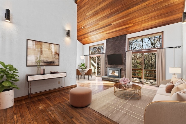 living room with wood-type flooring, a fireplace, and wood ceiling